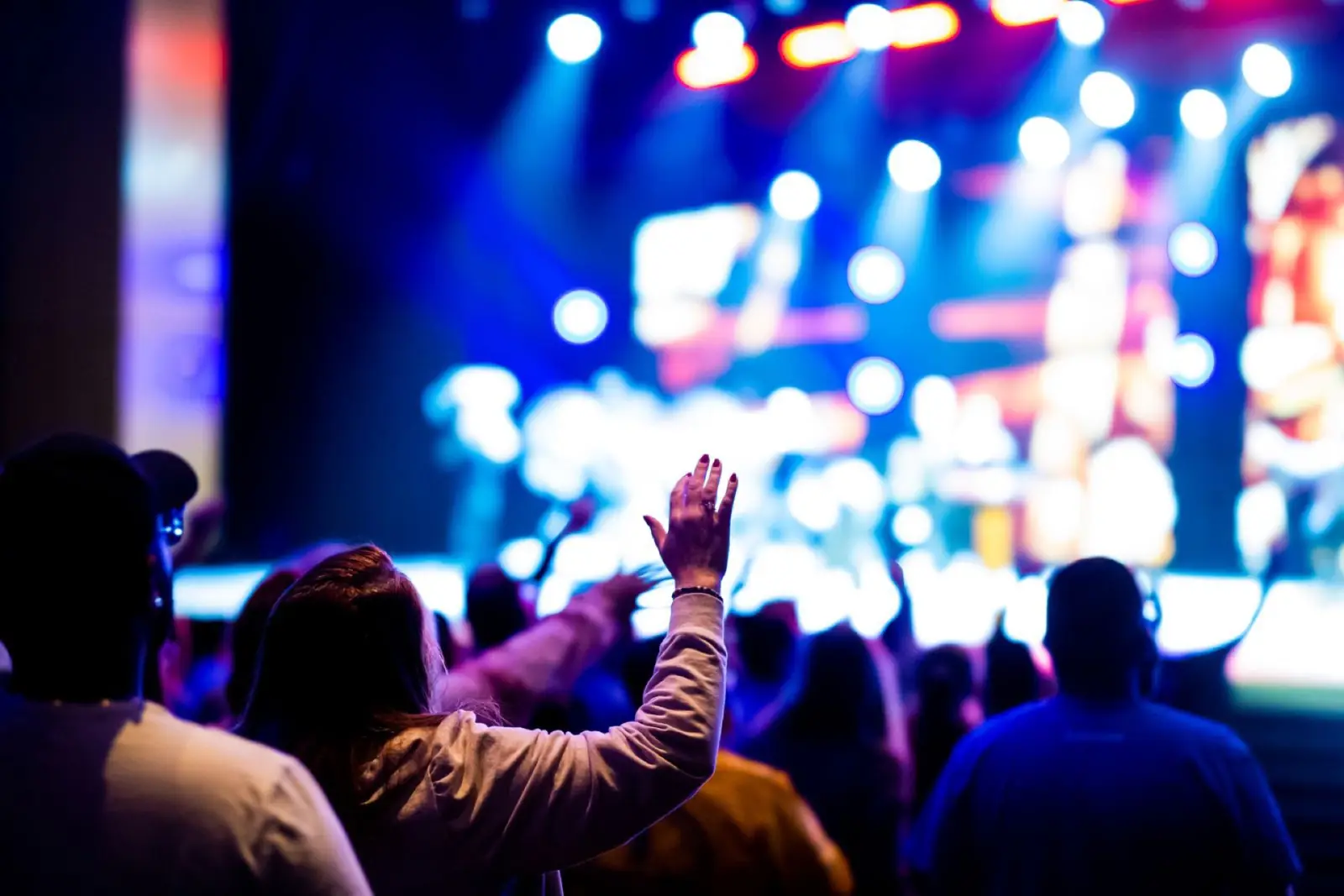 Concert audience beneath blue and violet stage lights
