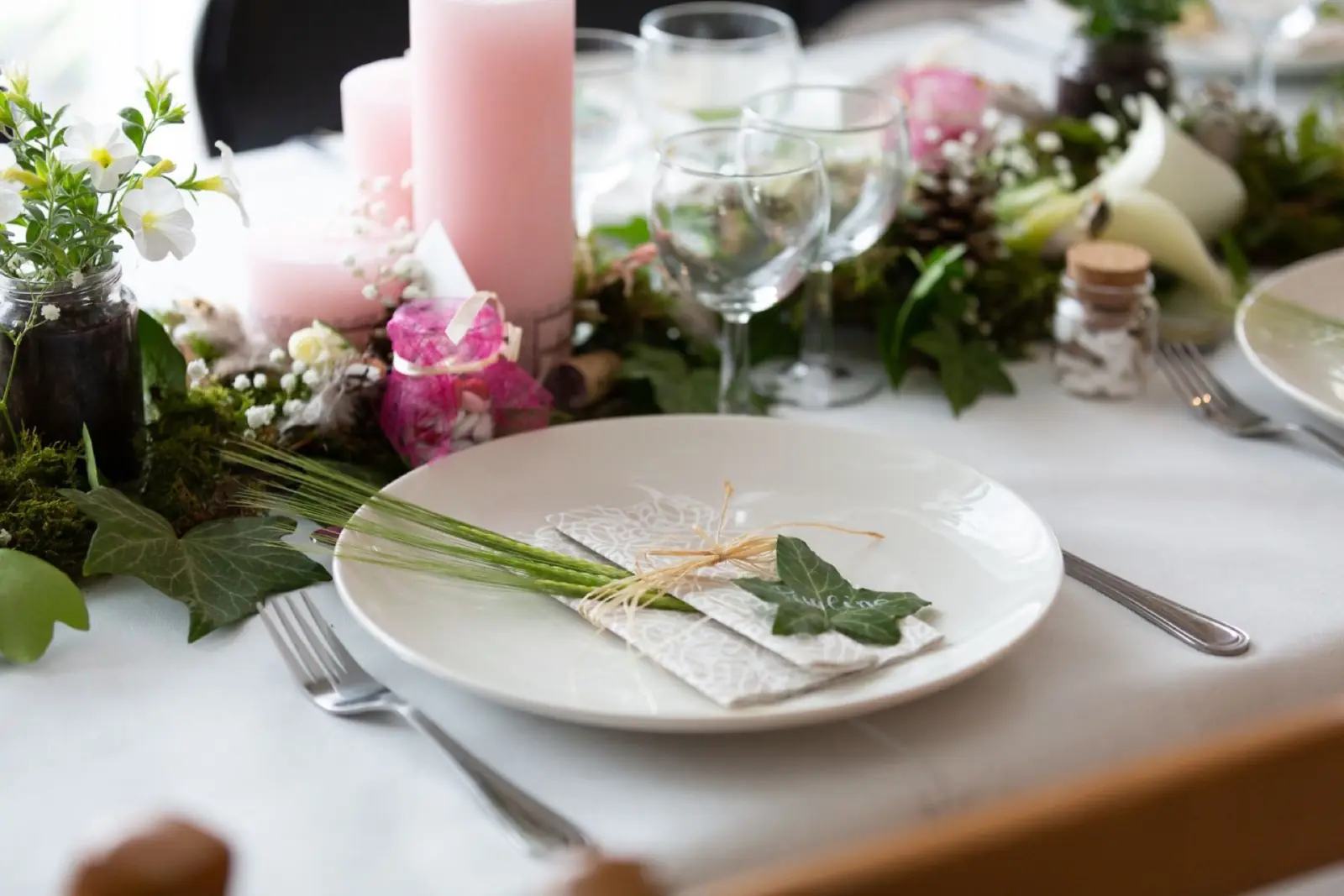 Floral place setting with candles at an elegant reception